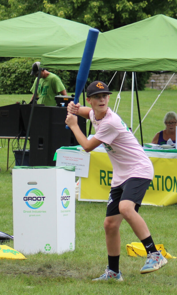 Boy at bat getting ready to hit a wiffle ball.