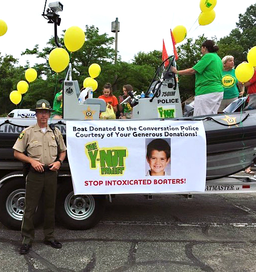 Banner with Tony Borcia's picture on a boat donated to the IL Conservation Police by Y-noT Project.